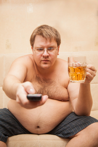 500 fat man with beer belly front tv eats popcorn drinks beer